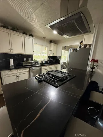 a kitchen with table and chairs