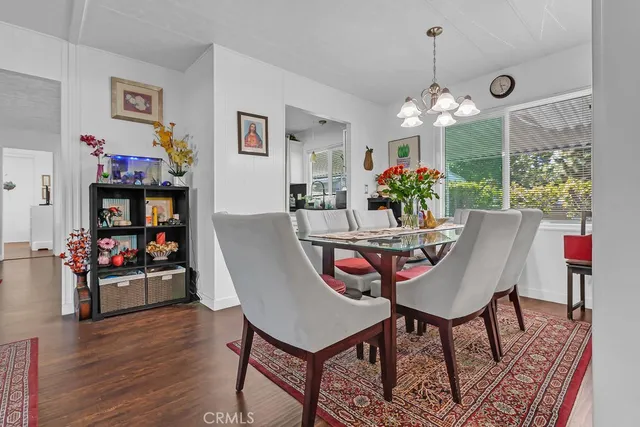 a view of a dining room with furniture wooden floor and chandelier