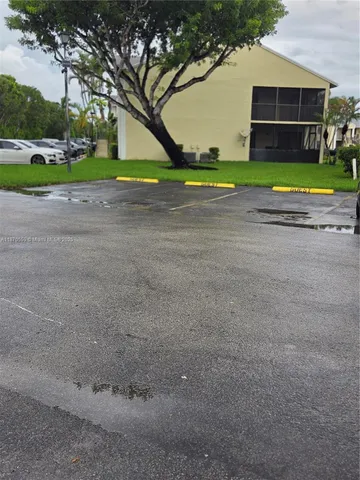 a view of road and trees in the background