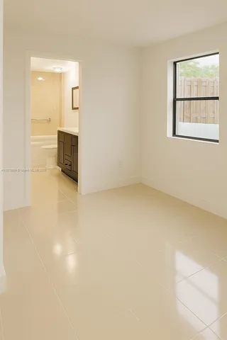 an empty room with windows and cabinet