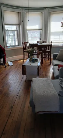 a dining room with furniture and wooden floor