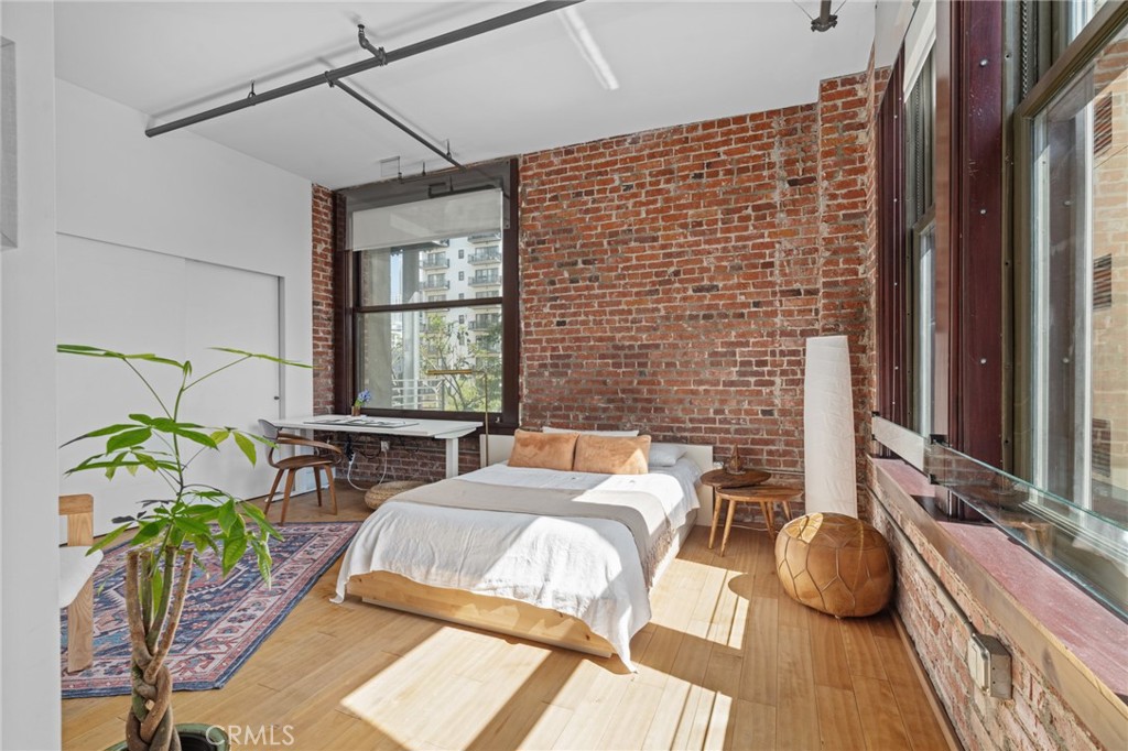 460 South Spring Street, Unit 302 Los Angeles, CA 90013 - Photo 13 of 24 a bedroom with a bed dresser and a window