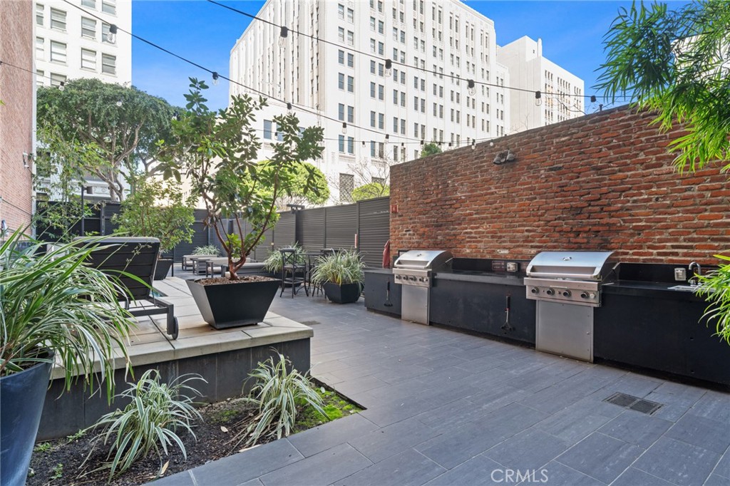 460 South Spring Street, Unit 302 Los Angeles, CA 90013 - Photo 17 of 24 a outdoor living space with a stove and chairs