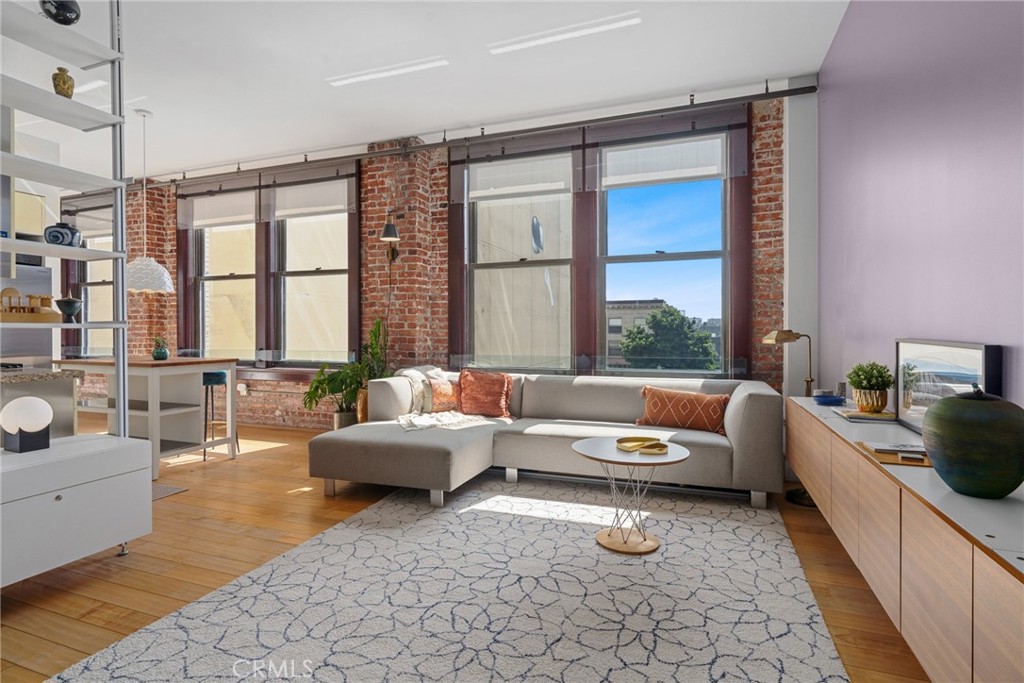 460 South Spring Street, Unit 302 Los Angeles, CA 90013 - Photo 6 of 24 a living room with furniture and a potted plant