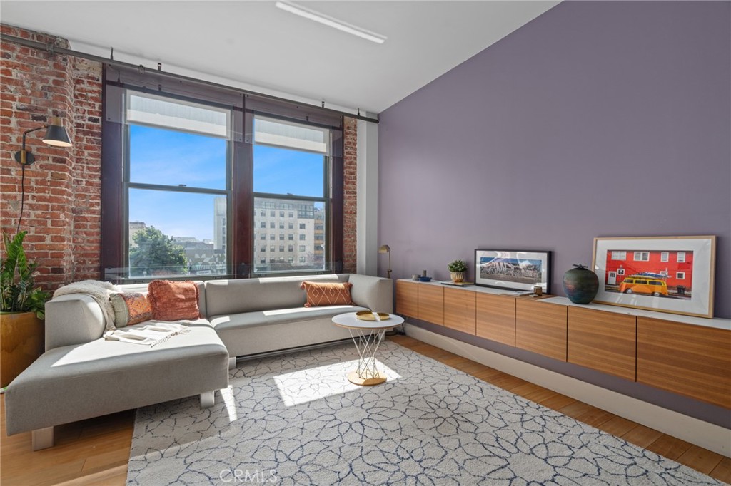 460 South Spring Street, Unit 302 Los Angeles, CA 90013 - Photo 8 of 24 a living room with furniture and a large window