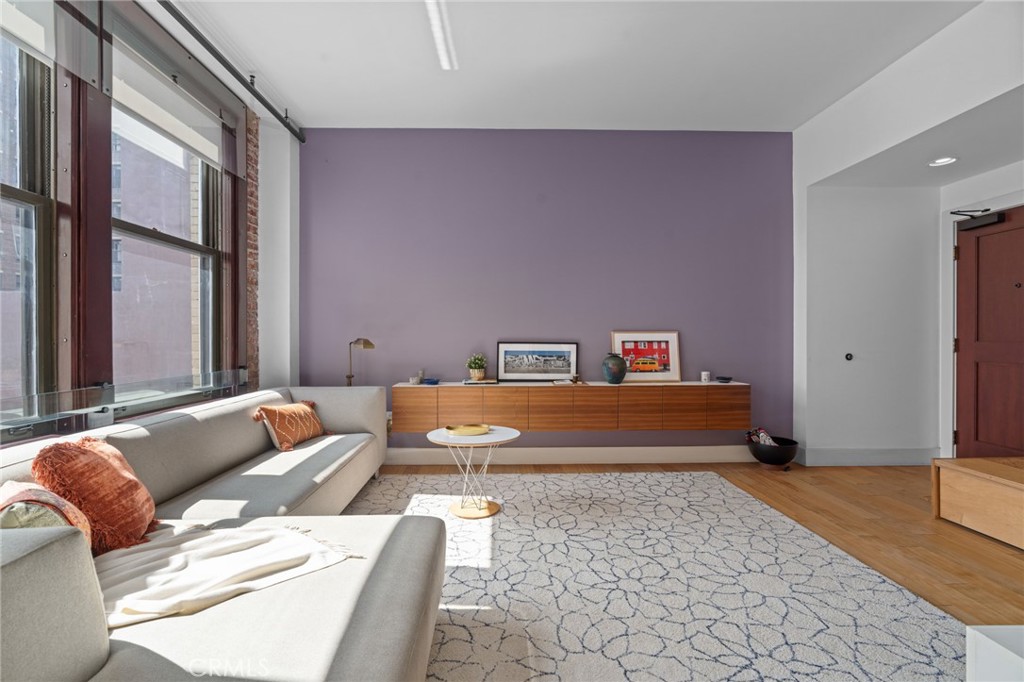 460 South Spring Street, Unit 302 Los Angeles, CA 90013 - Photo 9 of 24 a bedroom with furniture and a couch