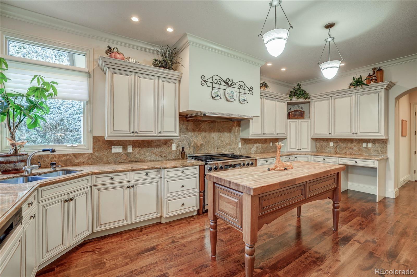 23 Foxtail Circle Cherry Hills Village, CO 80113 - Photo 18 of 40 a kitchen with a stove cabinets and wooden floor