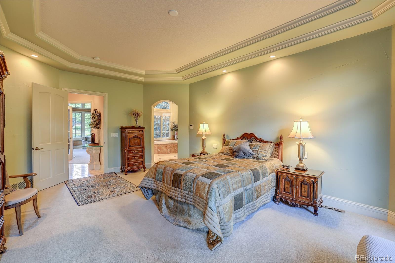 23 Foxtail Circle Cherry Hills Village, CO 80113 - Photo 25 of 40 a spacious bedroom with a bed a mirror on dresser and a table