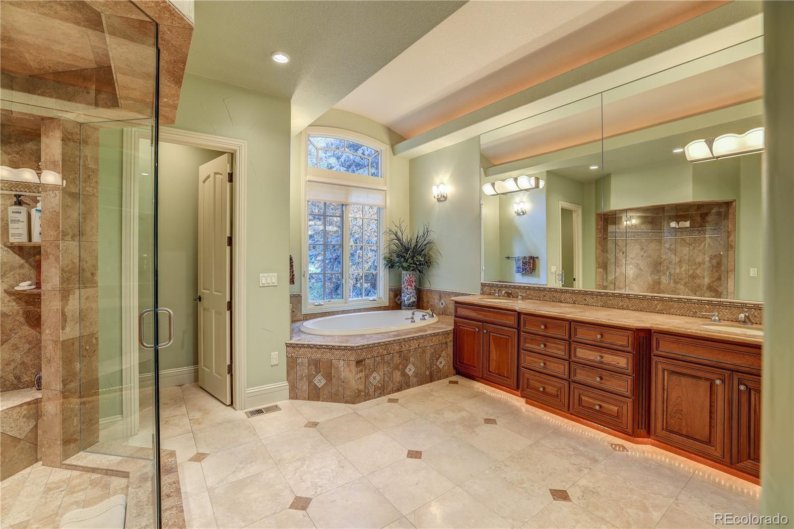 23 Foxtail Circle Cherry Hills Village, CO 80113 - Photo 26 of 40 a spacious bathroom with a granite countertop sink mirror and shower