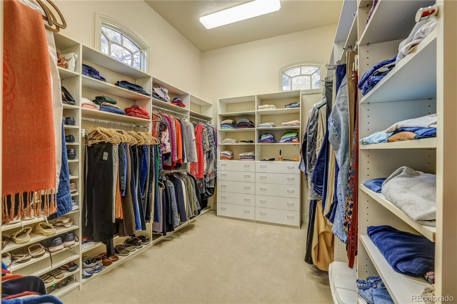 23 Foxtail Circle Cherry Hills Village, CO 80113 - Photo 29 of 40 a view of walk in closet with clothes and shoes