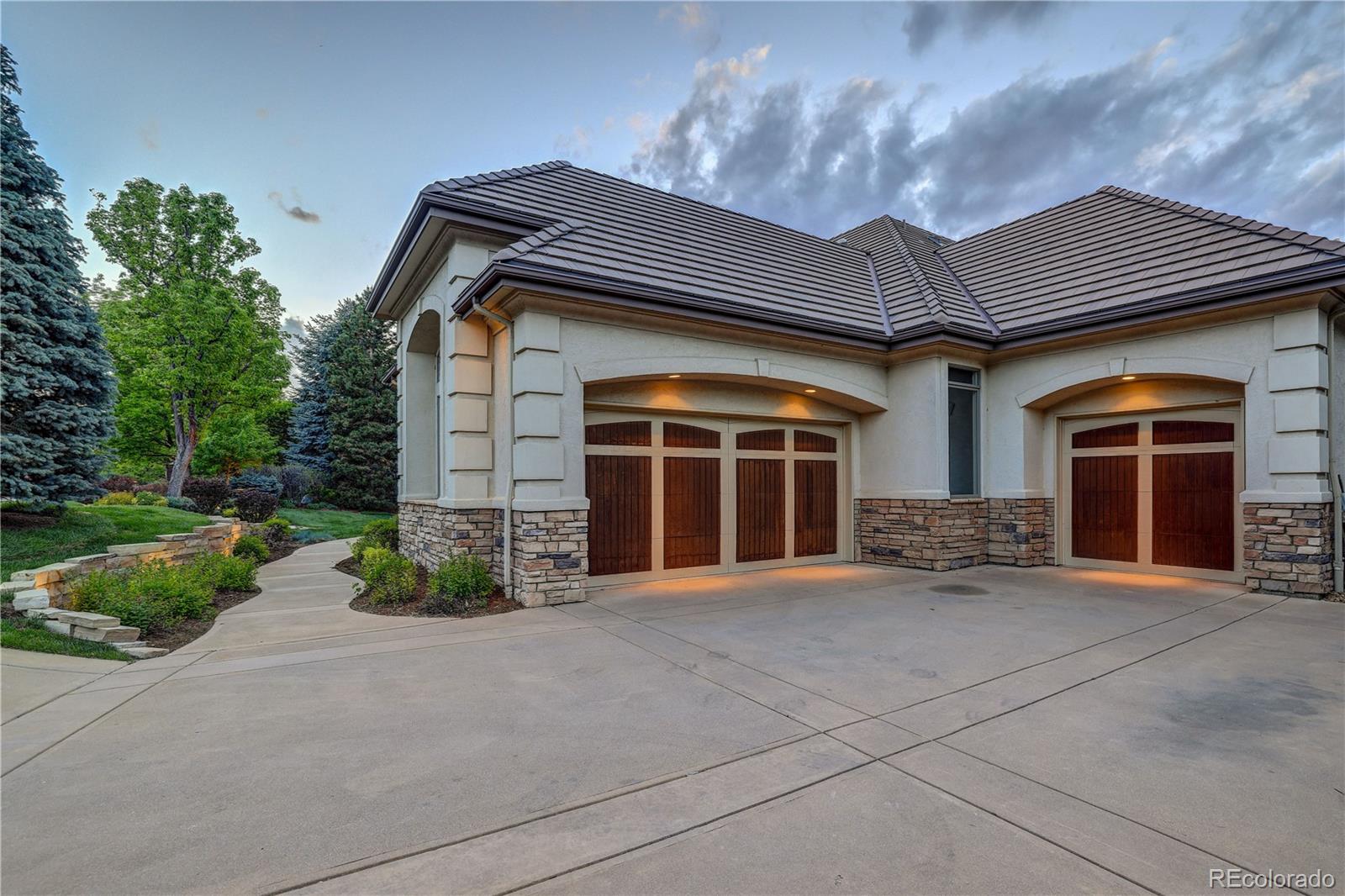 23 Foxtail Circle Cherry Hills Village, CO 80113 - Photo 3 of 40 a front view of a house with a yard and garage