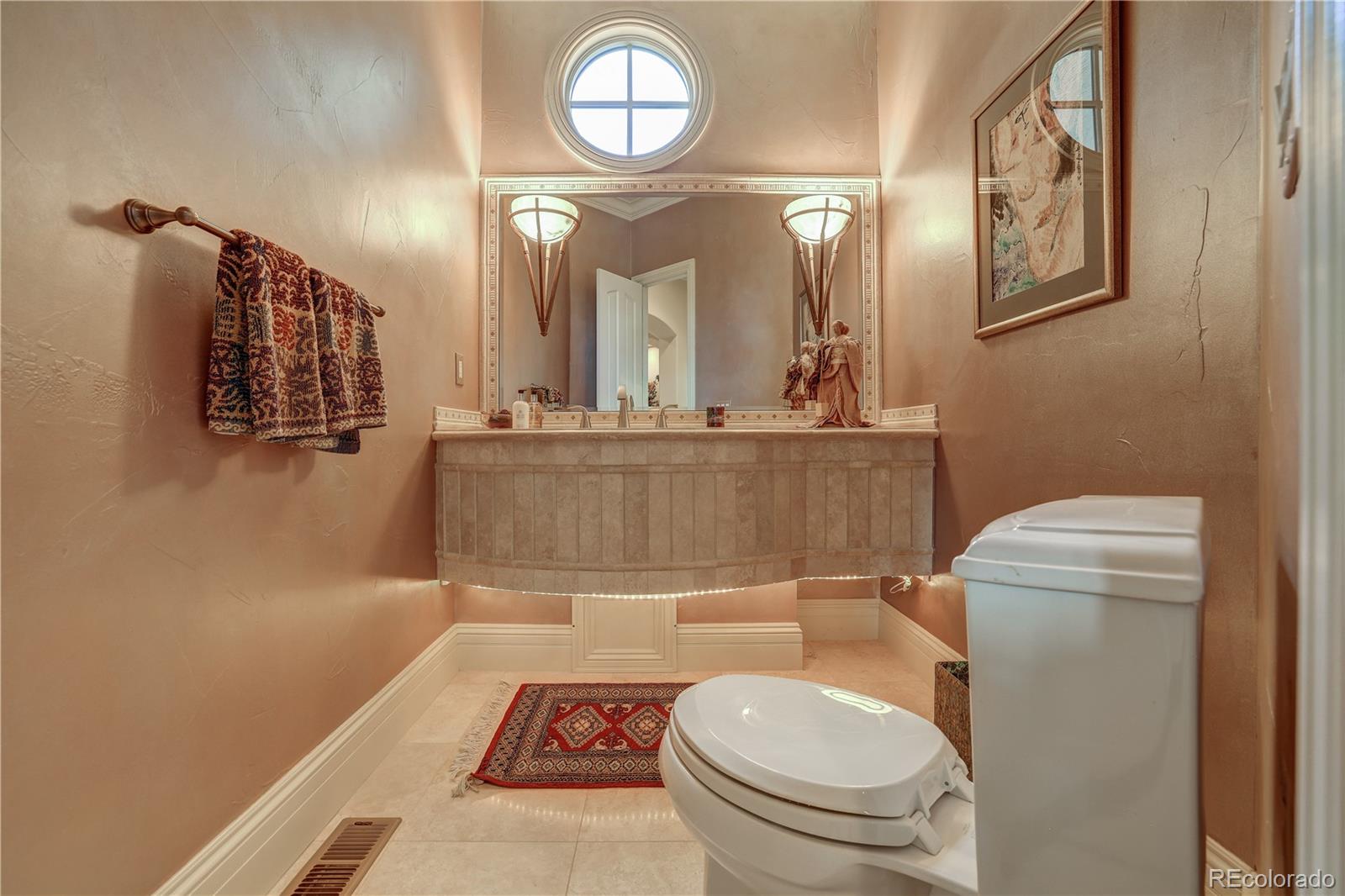 23 Foxtail Circle Cherry Hills Village, CO 80113 - Photo 31 of 40 a bathroom with a toilet a sink and mirror