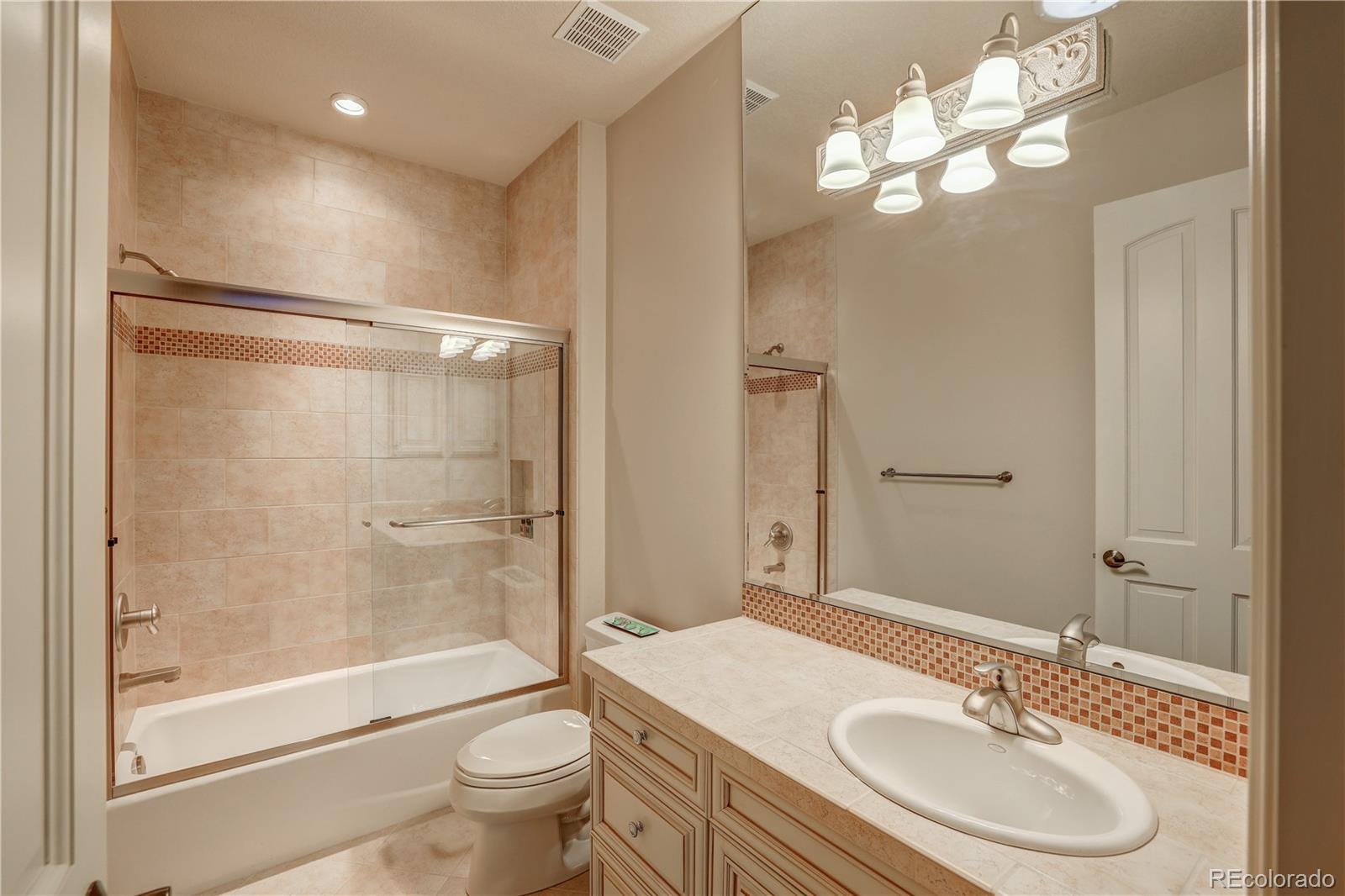 23 Foxtail Circle Cherry Hills Village, CO 80113 - Photo 38 of 40 a bathroom with a sink a toilet and shower