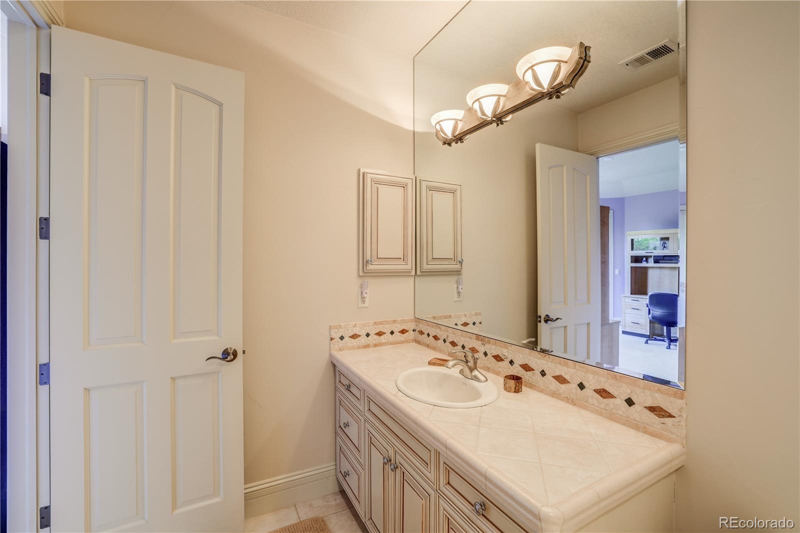 23 Foxtail Circle Cherry Hills Village, CO 80113 - Photo 40 of 40 a bathroom with a sink and a mirror