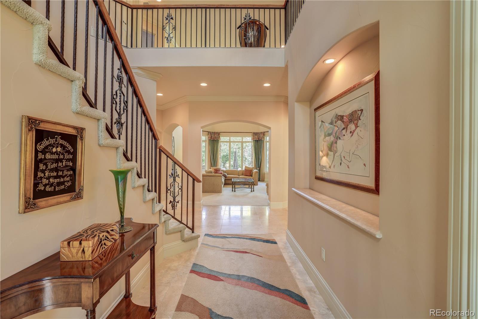23 Foxtail Circle Cherry Hills Village, CO 80113 - Photo 8 of 40 a view of an entryway with wooden floor and stairs