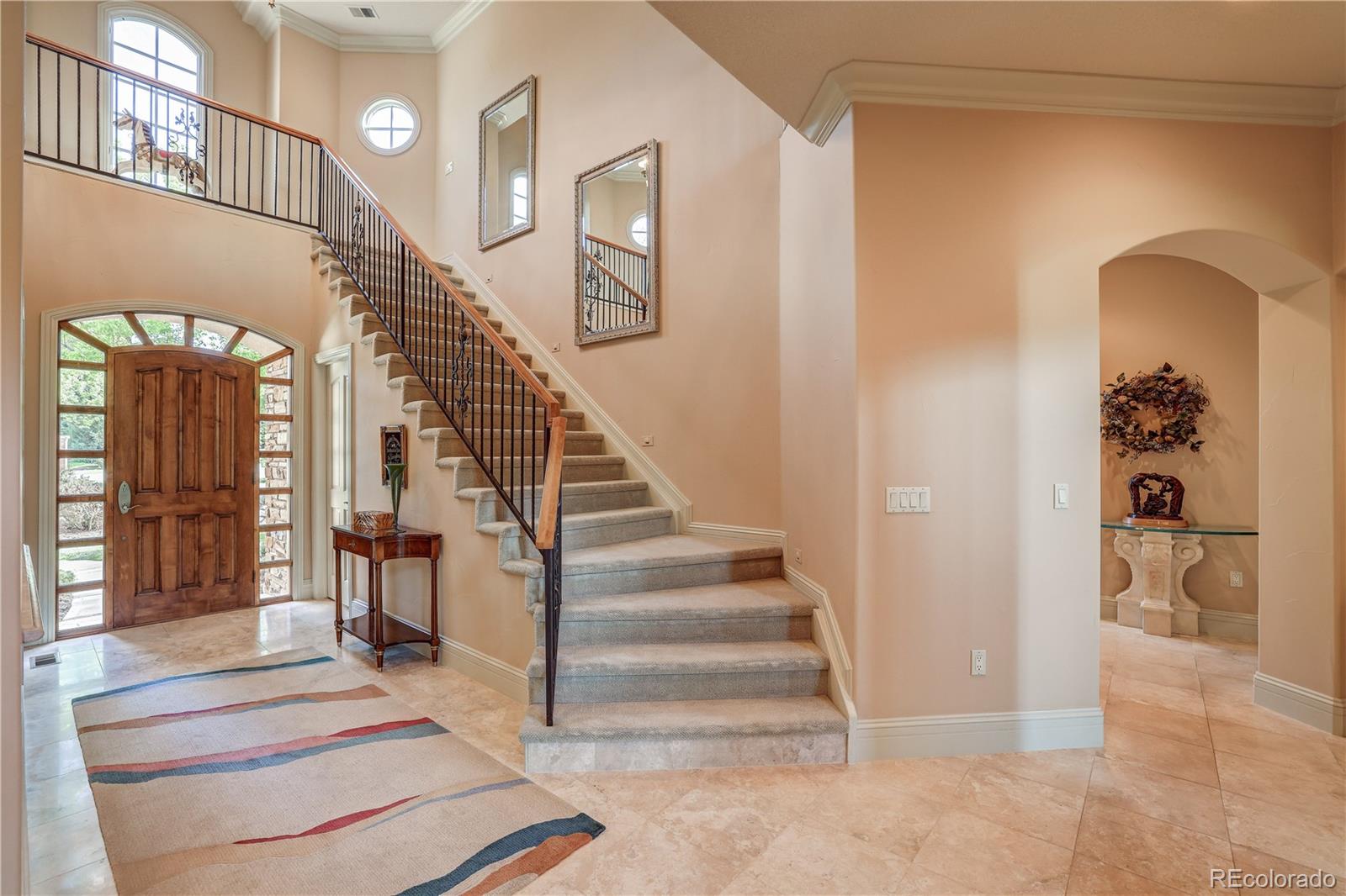 23 Foxtail Circle Cherry Hills Village, CO 80113 - Photo 9 of 40 a view of staircase with lots of frames on wall and a chandelier