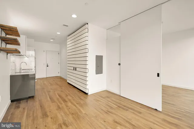 a view of a kitchen with a sink and dishwasher wooden floor