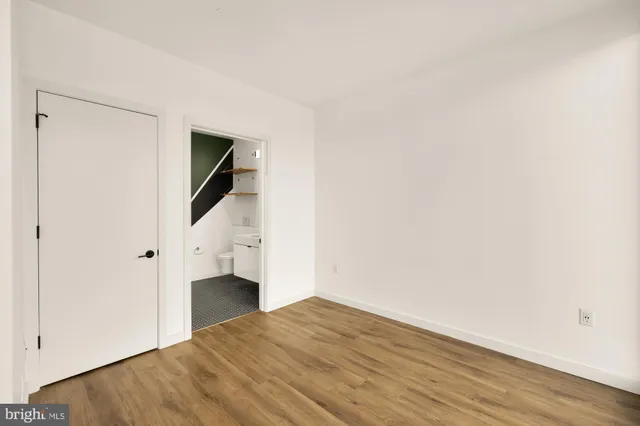 a view of a livingroom with wooden floor and staircase