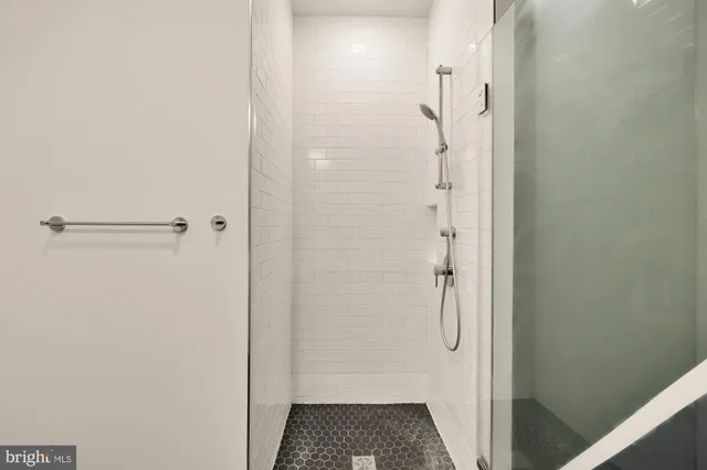 a living room with furniture and floor to ceiling windows