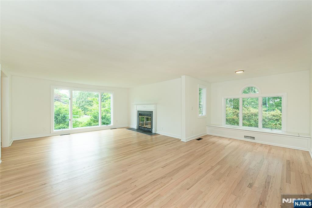 163 Sand Spring Road Morristown, NJ 07960 - Photo 15 of 39 an empty room with wooden floor and windows