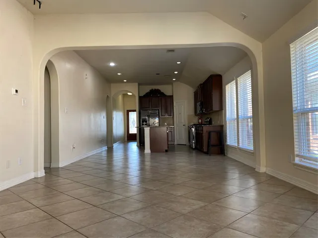 a view of a hallway with a couch and chandelier
