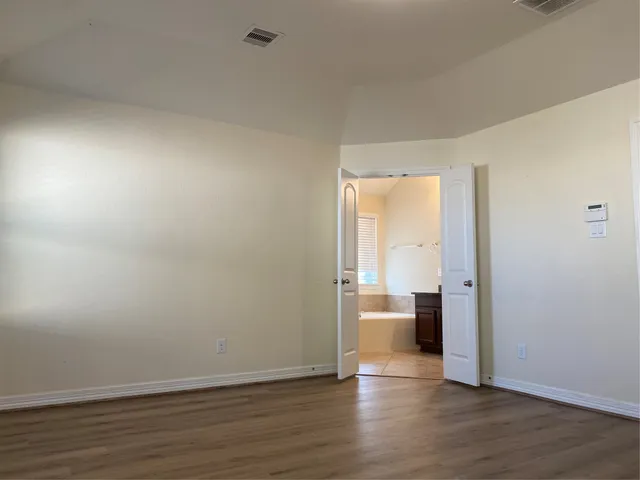 a view of a room with wooden floor and a sink