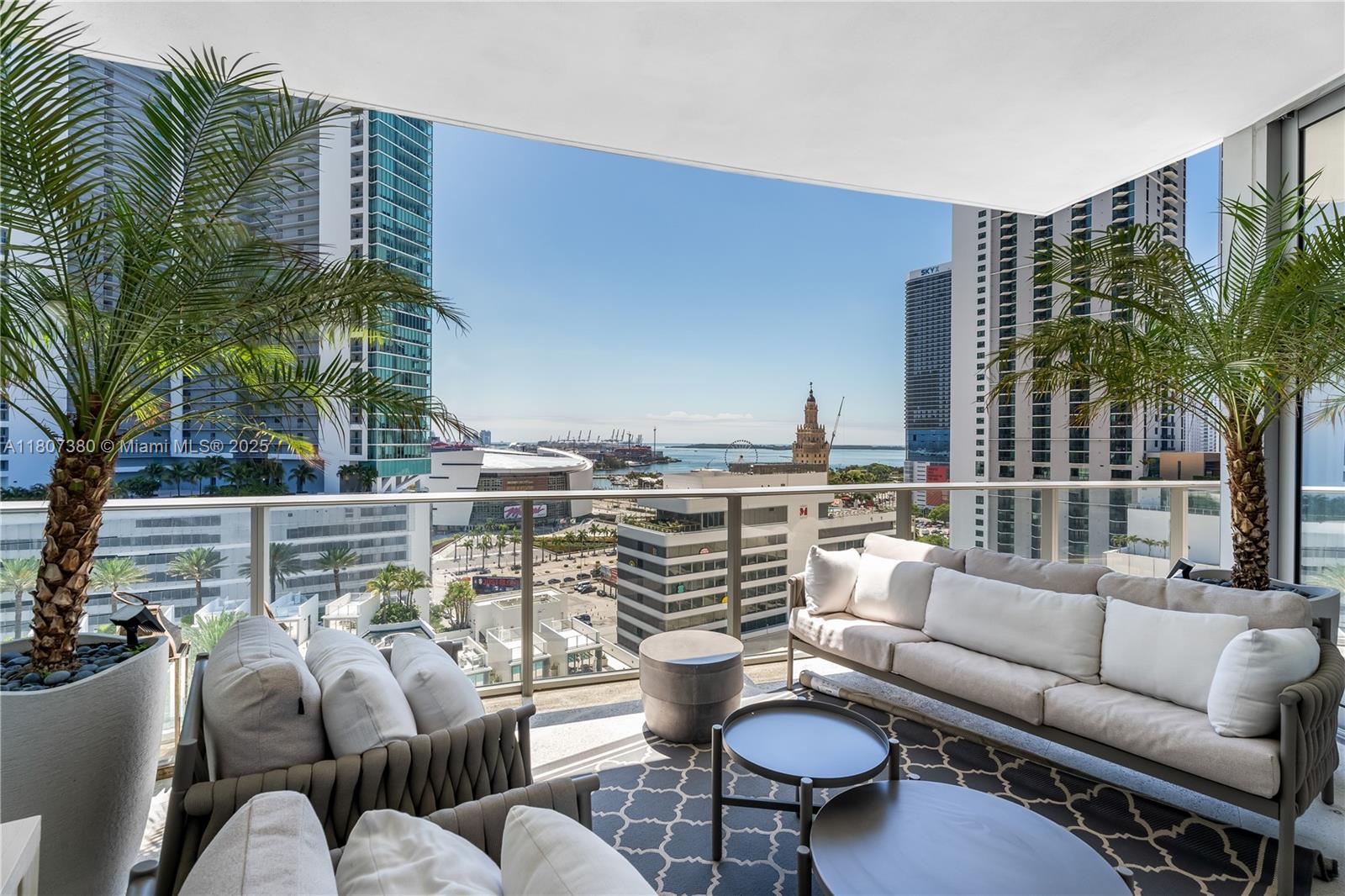 851 Northeast 1st Avenue, Unit 1409 Miami, FL 33132 - Photo 1 of 43 a balcony with furniture and a potted plant