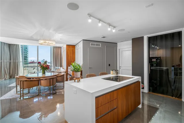 a kitchen with a sink refrigerator and cabinets
