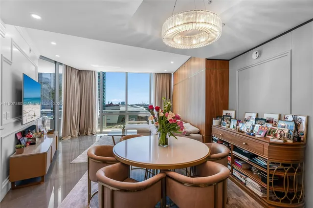 a dining room with furniture and a chandelier