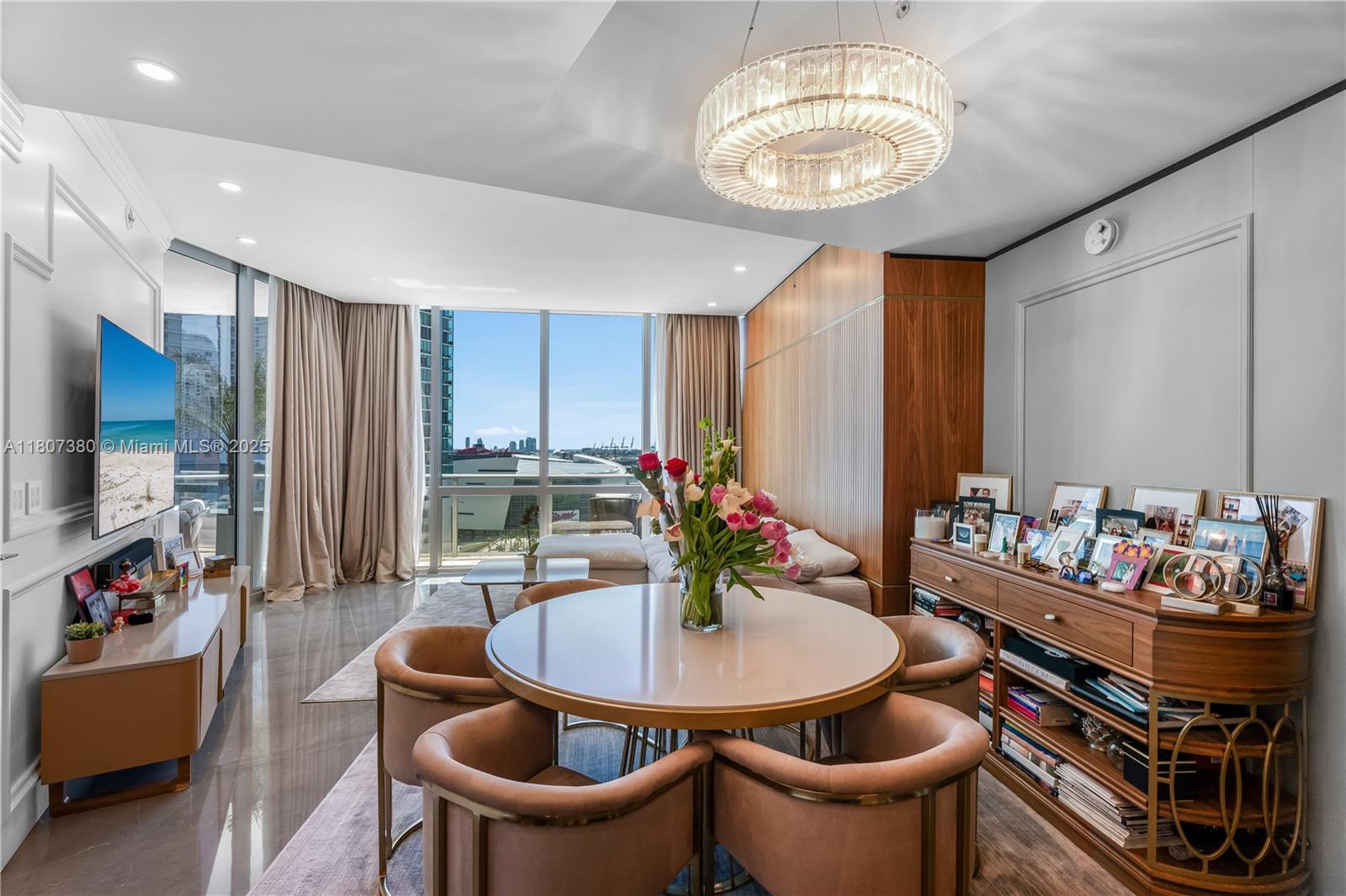 851 Northeast 1st Avenue, Unit 1409 Miami, FL 33132 - Photo 3 of 43 a dining room with furniture and a chandelier