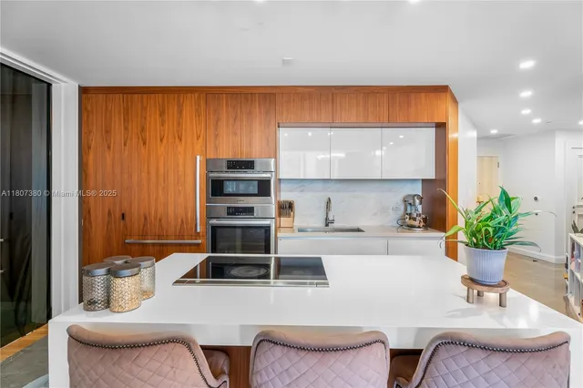 a kitchen with a table chairs stove and cabinets