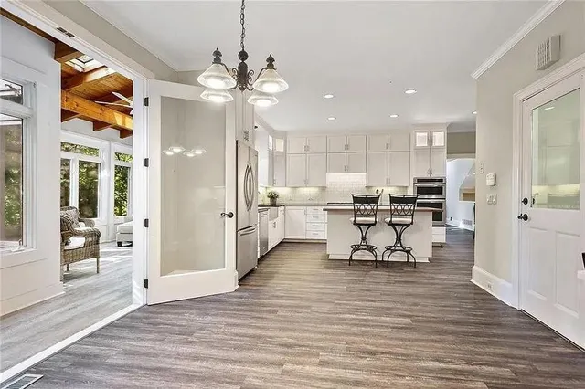 a view of a kitchen with dining room and wooden floor