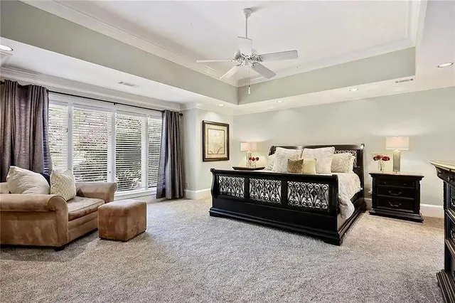 a bedroom with a bed a couch and dresser