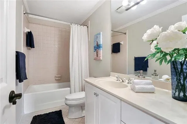a bathroom with a granite countertop sink a toilet and shower