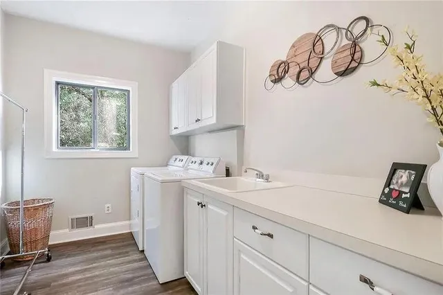 a utility room with a sink dryer and washer