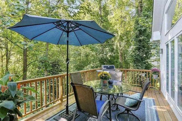 a view of balcony with furniture and umbrella