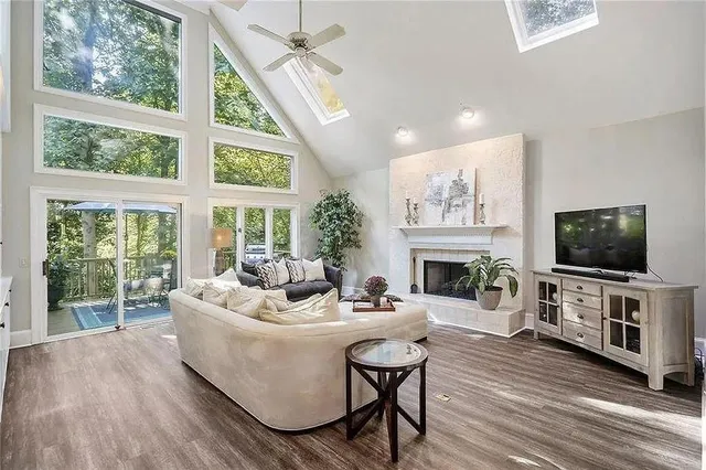 a living room with furniture a flat screen tv and a fireplace