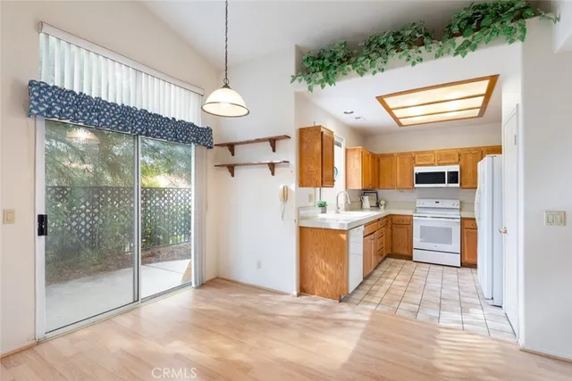 a view of a house with patio and a garden