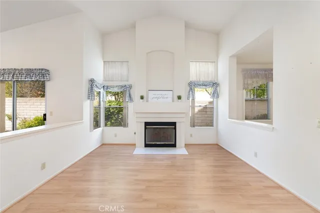 a dining room with furniture potted plants and wooden floor