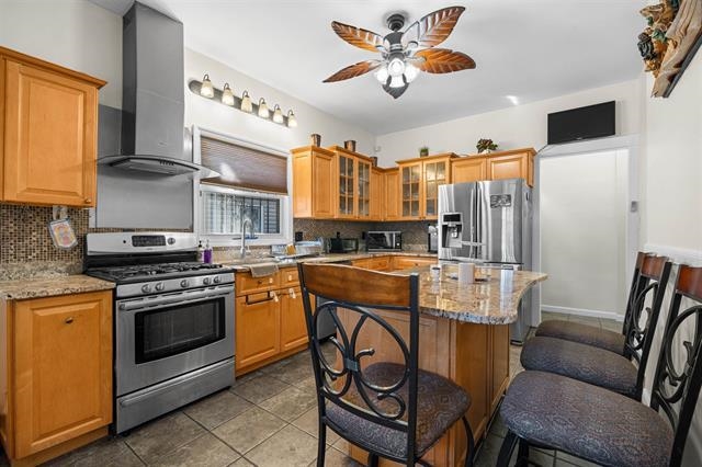 2746 John F. Kennedy Boulevard Jersey City, NJ 07306 - Photo 13 of 37 a kitchen with stainless steel appliances granite countertop a stove a sink dishwasher and a refrigerator with wooden floor