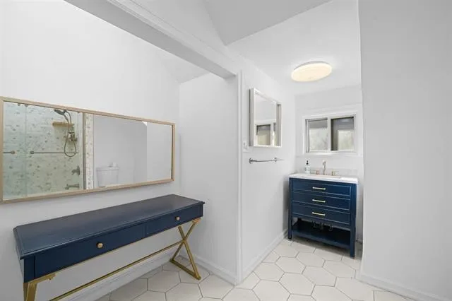 a view of room with flat screen tv and windows