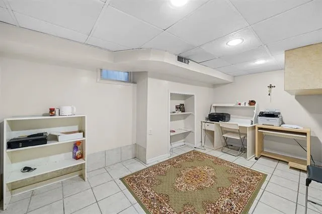 a kitchen with white cabinets and appliances