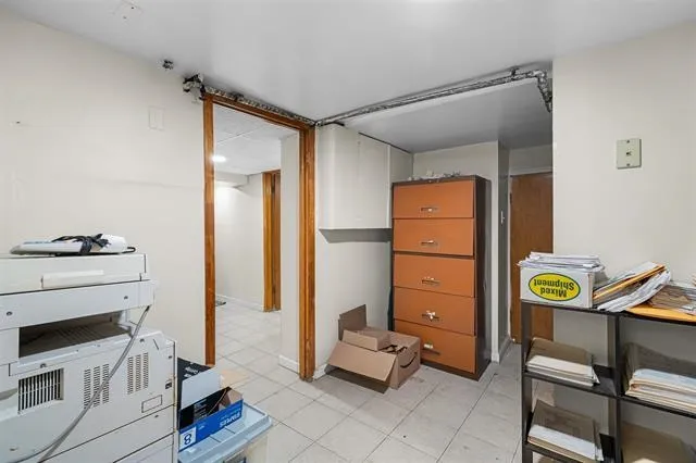 a view of a hallway with workspace and a window