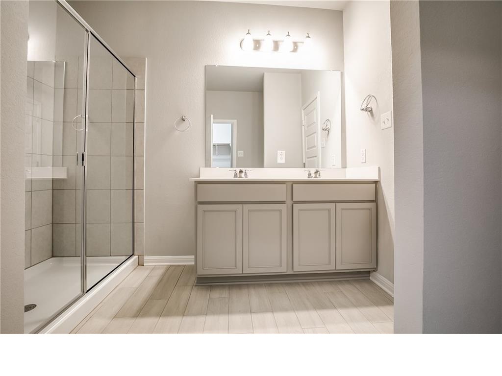 237 Unforgiven Lane Jarrell, TX 76537 - Photo 9 of 20 a bathroom with a sink a toilet and shower