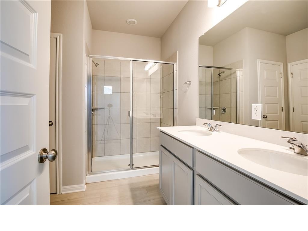 237 Unforgiven Lane Jarrell, TX 76537 - Photo 10 of 20 a bathroom with a sink double vanity and a shower