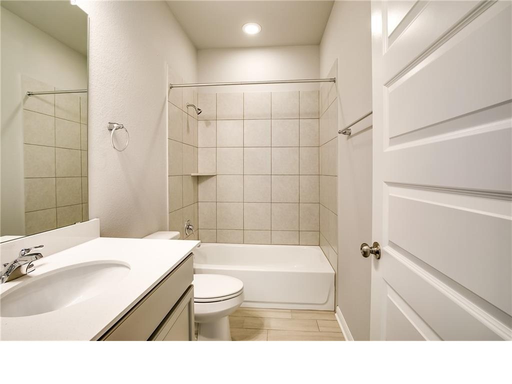 237 Unforgiven Lane Jarrell, TX 76537 - Photo 12 of 20 a bathroom with a sink toilet bathtub and shower