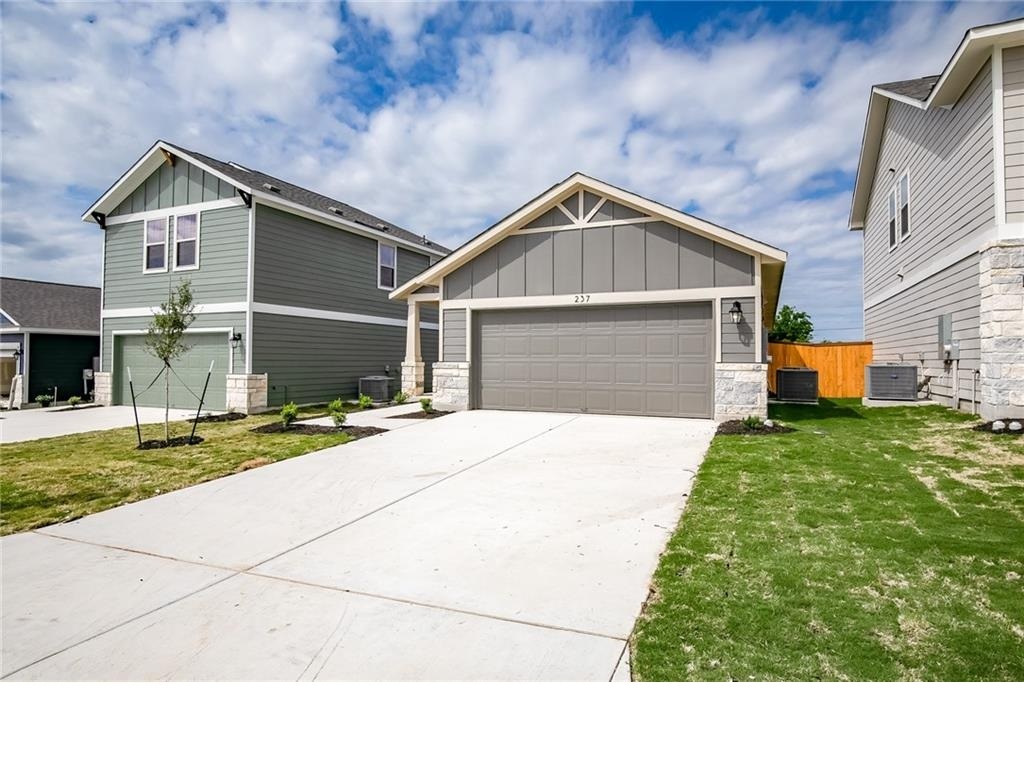 237 Unforgiven Lane Jarrell, TX 76537 - Photo 2 of 20 a front view of a house with a yard and garage