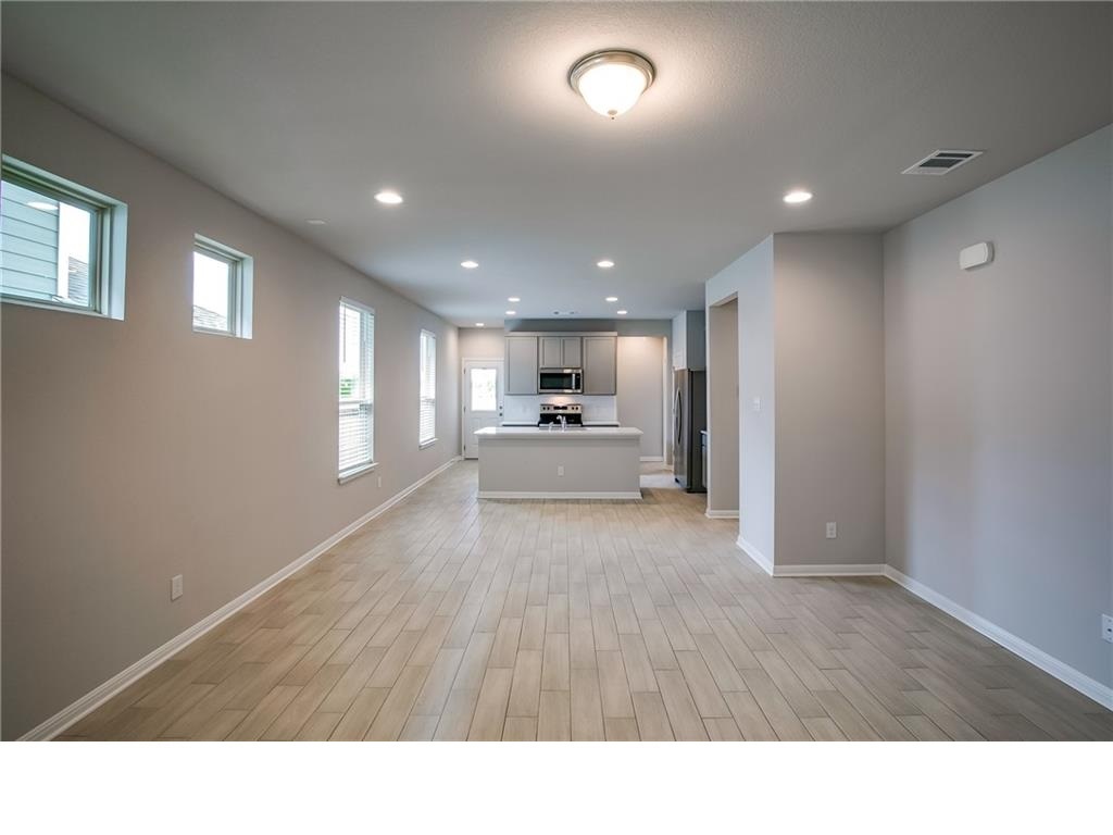 237 Unforgiven Lane Jarrell, TX 76537 - Photo 19 of 20 a open hall with kitchen and window