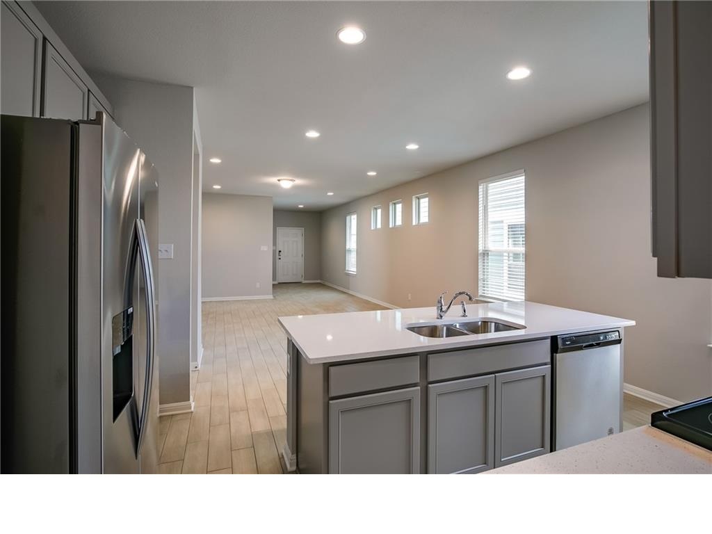 237 Unforgiven Lane Jarrell, TX 76537 - Photo 20 of 20 a kitchen with stainless steel appliances granite countertop a sink refrigerator and cabinets