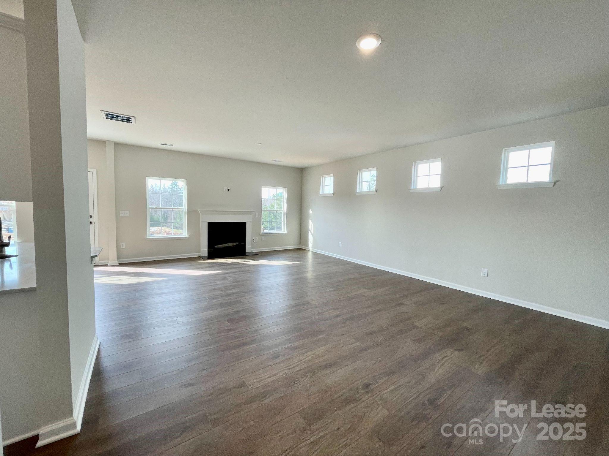15904 Capps Road Charlotte, NC 28278 - Photo 4 of 21 wooden floor in an empty room with a fireplace